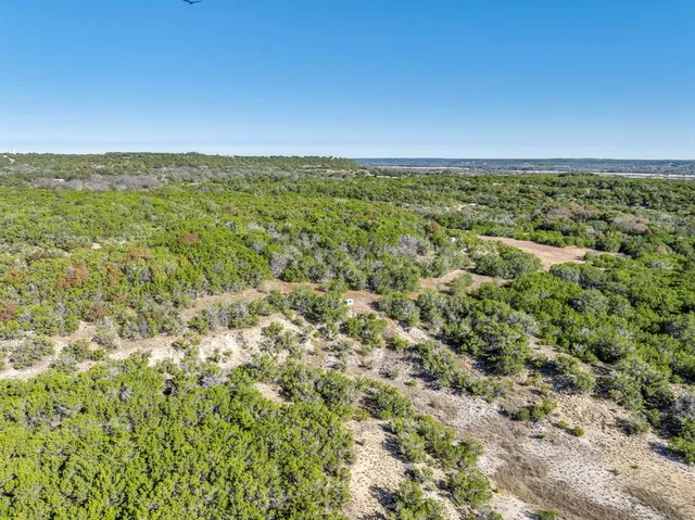 an aerial view of a houses with a yard