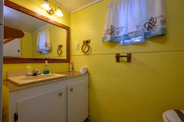 a bedroom with a bed dresser and a window