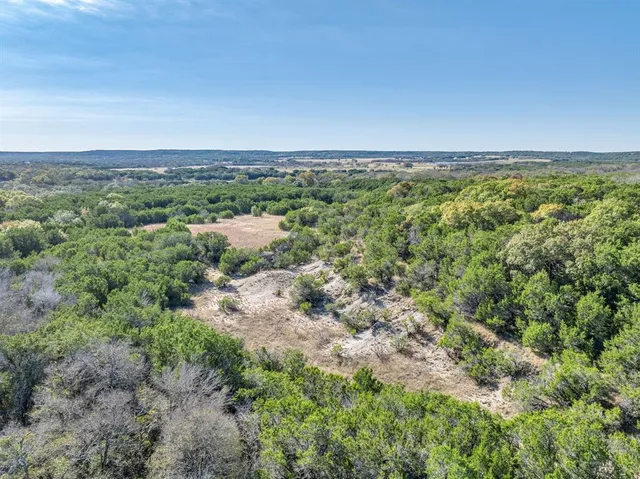 an empty room with yard and outdoor seating