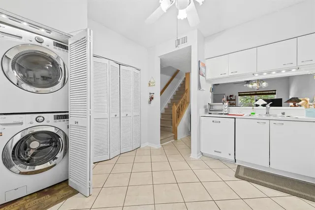 a utility room with cabinets dryer and washer