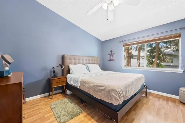 a bedroom with a bed lamp and a window