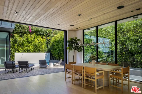 a balcony with table and chairs
