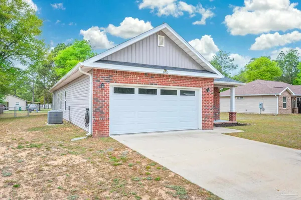 a view of a house with a yard and garage