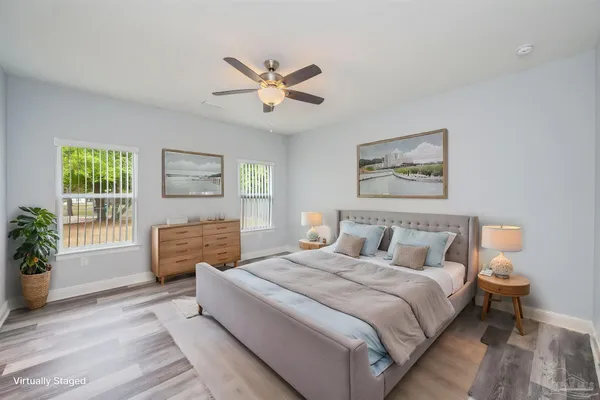 a bedroom with a bed lamps and window