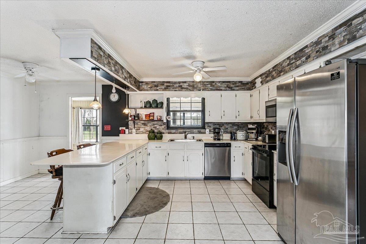 295 Columbus Circle Brewton, AL 36426 - Photo 11 of 32 a kitchen with sink cabinets and stainless steel appliances