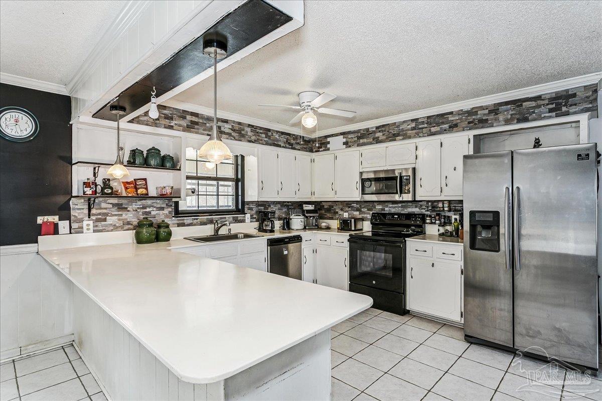 295 Columbus Circle Brewton, AL 36426 - Photo 12 of 32 a kitchen with refrigerator and white cabinets