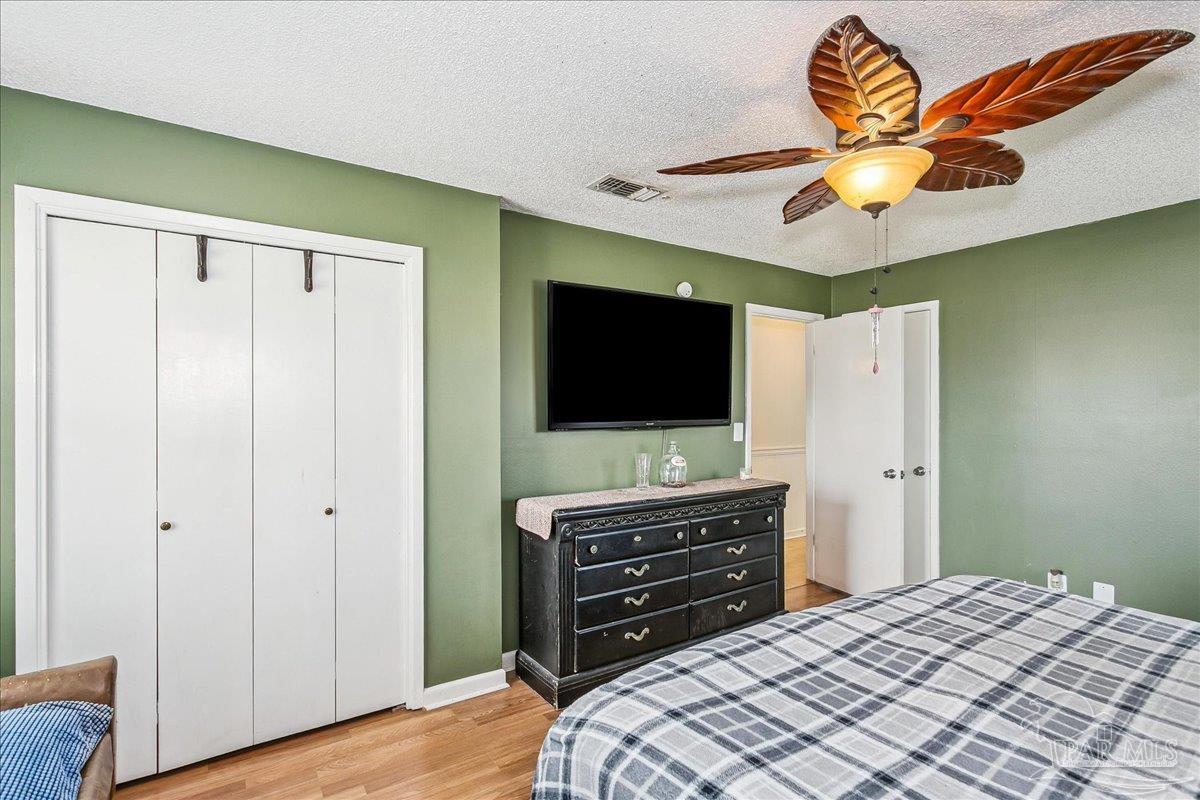 295 Columbus Circle Brewton, AL 36426 - Photo 16 of 32 a bedroom with a bed and a flat screen tv