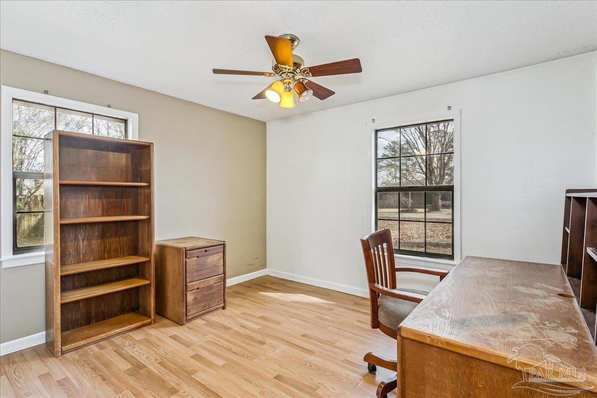 295 Columbus Circle Brewton, AL 36426 - Photo 19 of 32 a view of workspace with wooden floor shelves