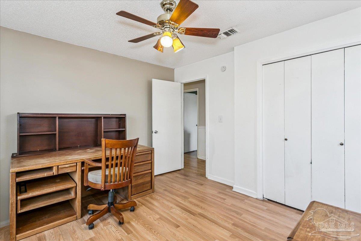 295 Columbus Circle Brewton, AL 36426 - Photo 20 of 32 a bedroom with a bed and a ceiling fan