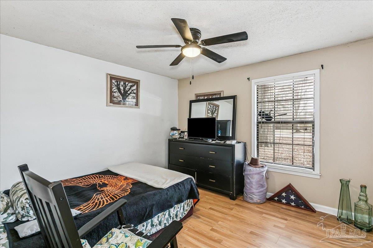 295 Columbus Circle Brewton, AL 36426 - Photo 21 of 32 a bedroom with a bed and a flat screen tv