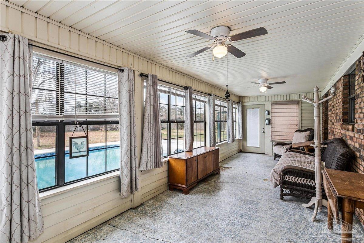 295 Columbus Circle Brewton, AL 36426 - Photo 23 of 32 a living room with furniture a ceiling fan and a large window