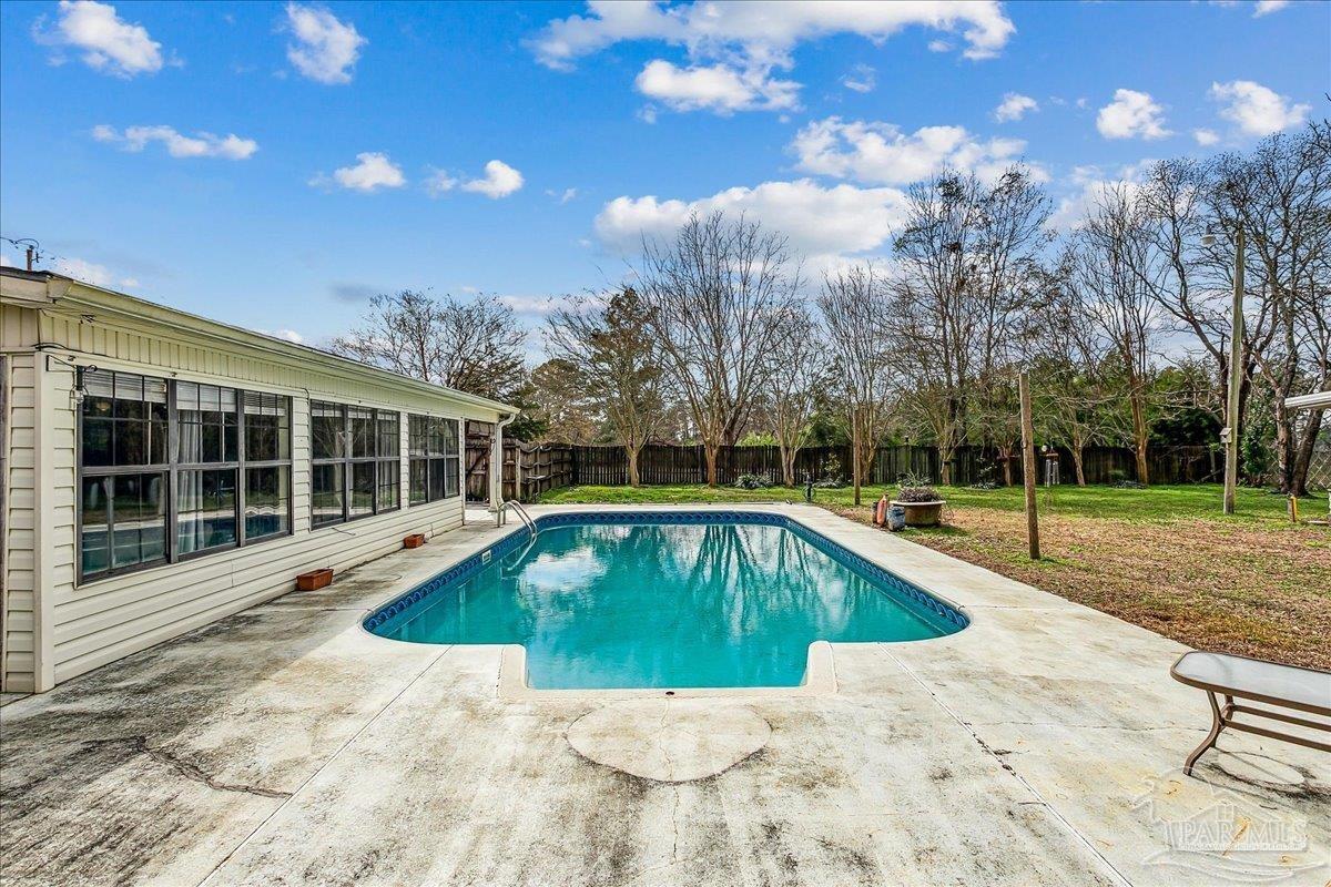 295 Columbus Circle Brewton, AL 36426 - Photo 26 of 32 a view of a swimming pool with a yard