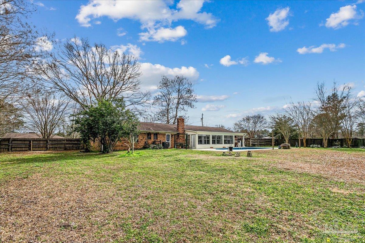 295 Columbus Circle Brewton, AL 36426 - Photo 29 of 32 a view of a house with a yard and a large tree