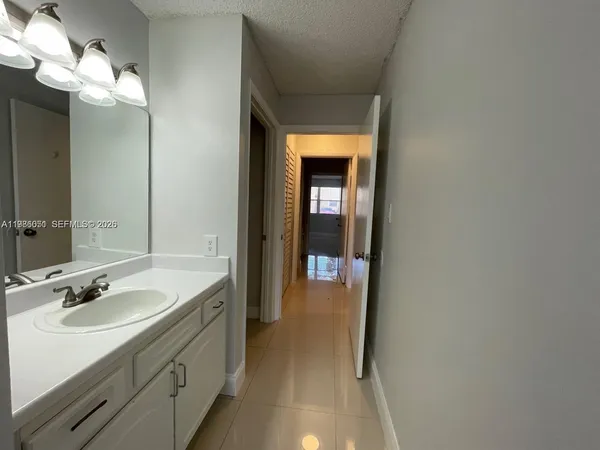 a en suite bathroom with a sink and a mirror