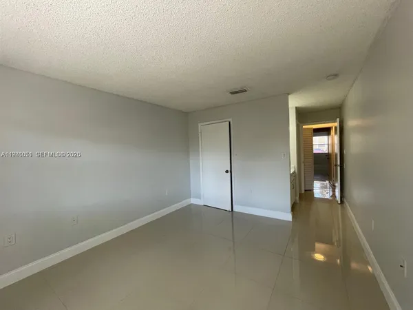 an empty room with closet area