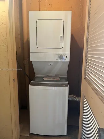 a view of a house with a large tree and a yard