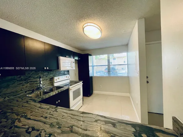 a kitchen with lots of counter space and windows