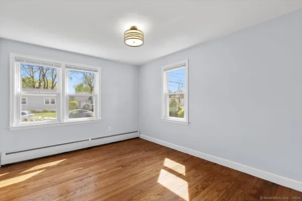 a view of a livingroom with wooden floor and window