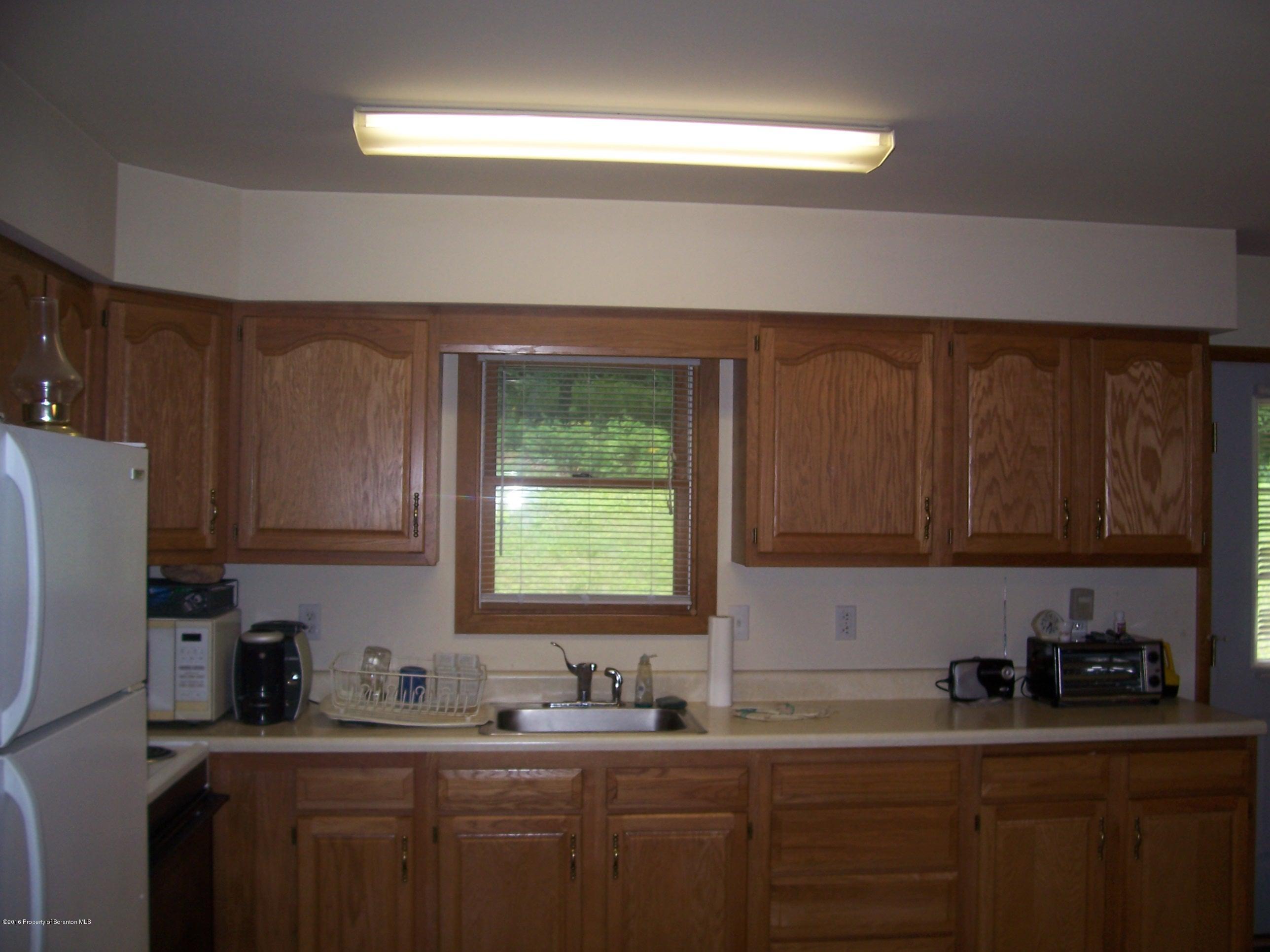 470 Blue Stone Road Meshoppen, PA 18630 - Photo 6 of 13 a kitchen with a sink a window and cabinets