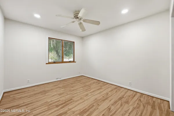a view of a hallway with wooden cabinets