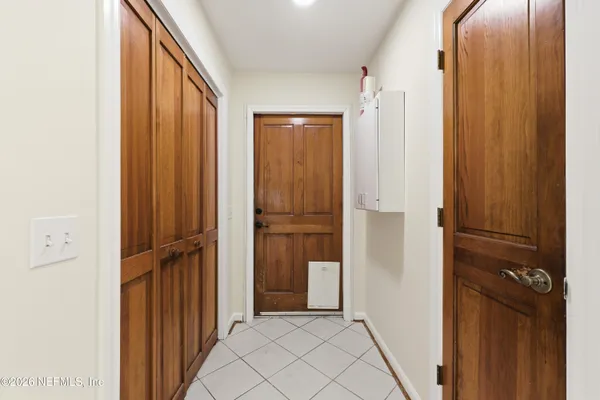 a backyard of a house with plants and tree