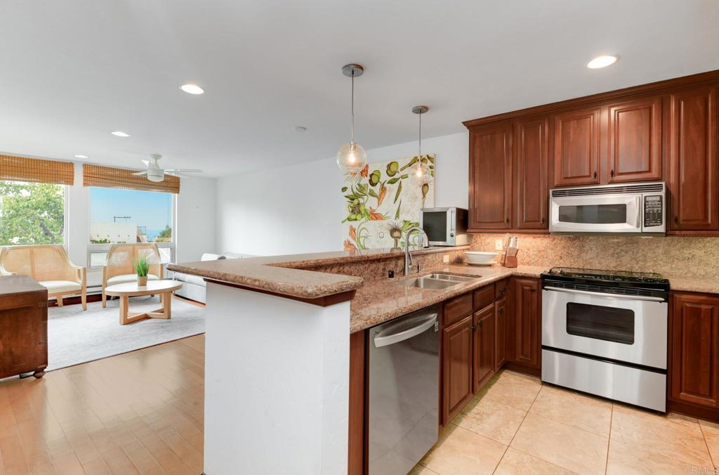 935 Genter Street, Unit 212 La Jolla, CA 92037 - Photo 13 of 23 a kitchen with a sink stove and microwave