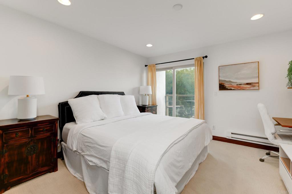 935 Genter Street, Unit 212 La Jolla, CA 92037 - Photo 14 of 23 a bedroom with a bed and wooden floor