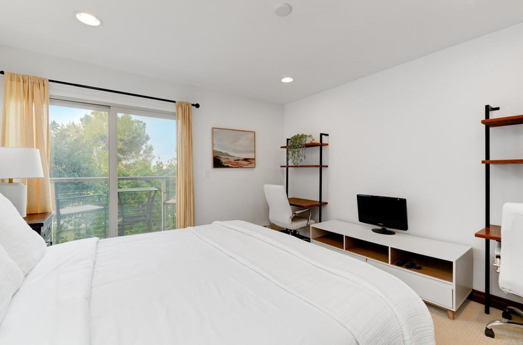 935 Genter Street, Unit 212 La Jolla, CA 92037 - Photo 15 of 23 a bedroom with a bed and large window