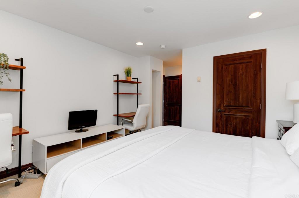 935 Genter Street, Unit 212 La Jolla, CA 92037 - Photo 17 of 23 a bedroom with a bed and a flat screen tv