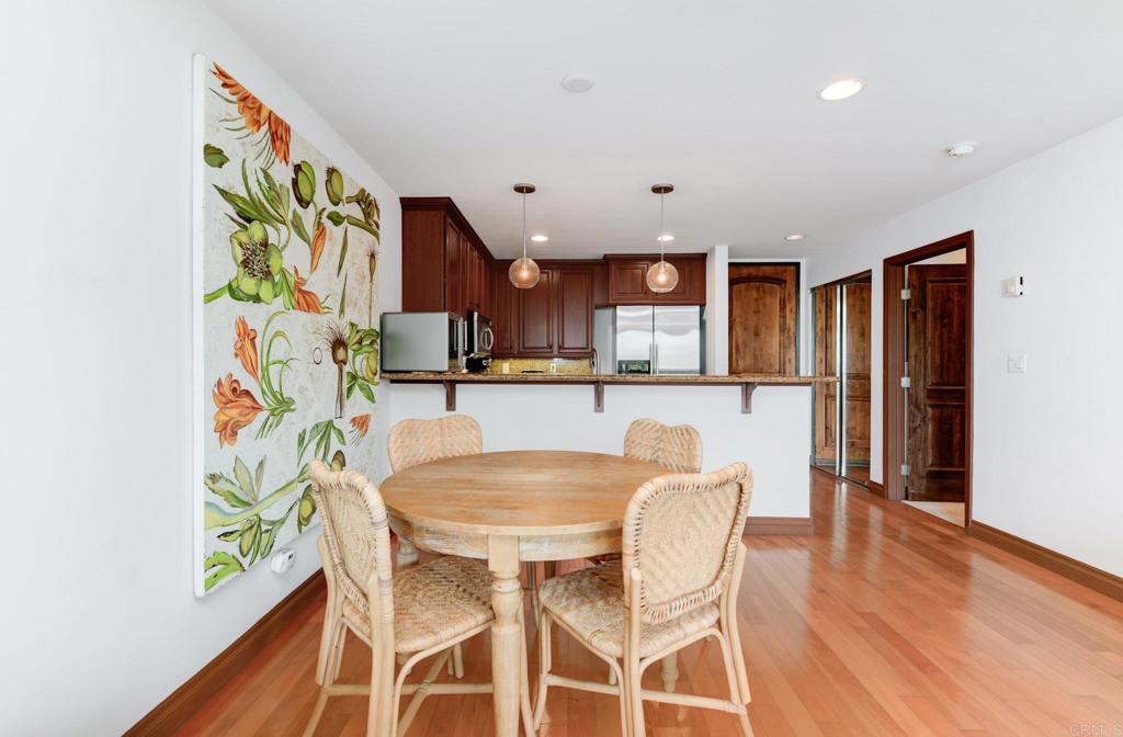935 Genter Street, Unit 212 La Jolla, CA 92037 - Photo 10 of 23 a view of a dining room with furniture and wooden floor