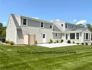 a white house with a garden in front of it