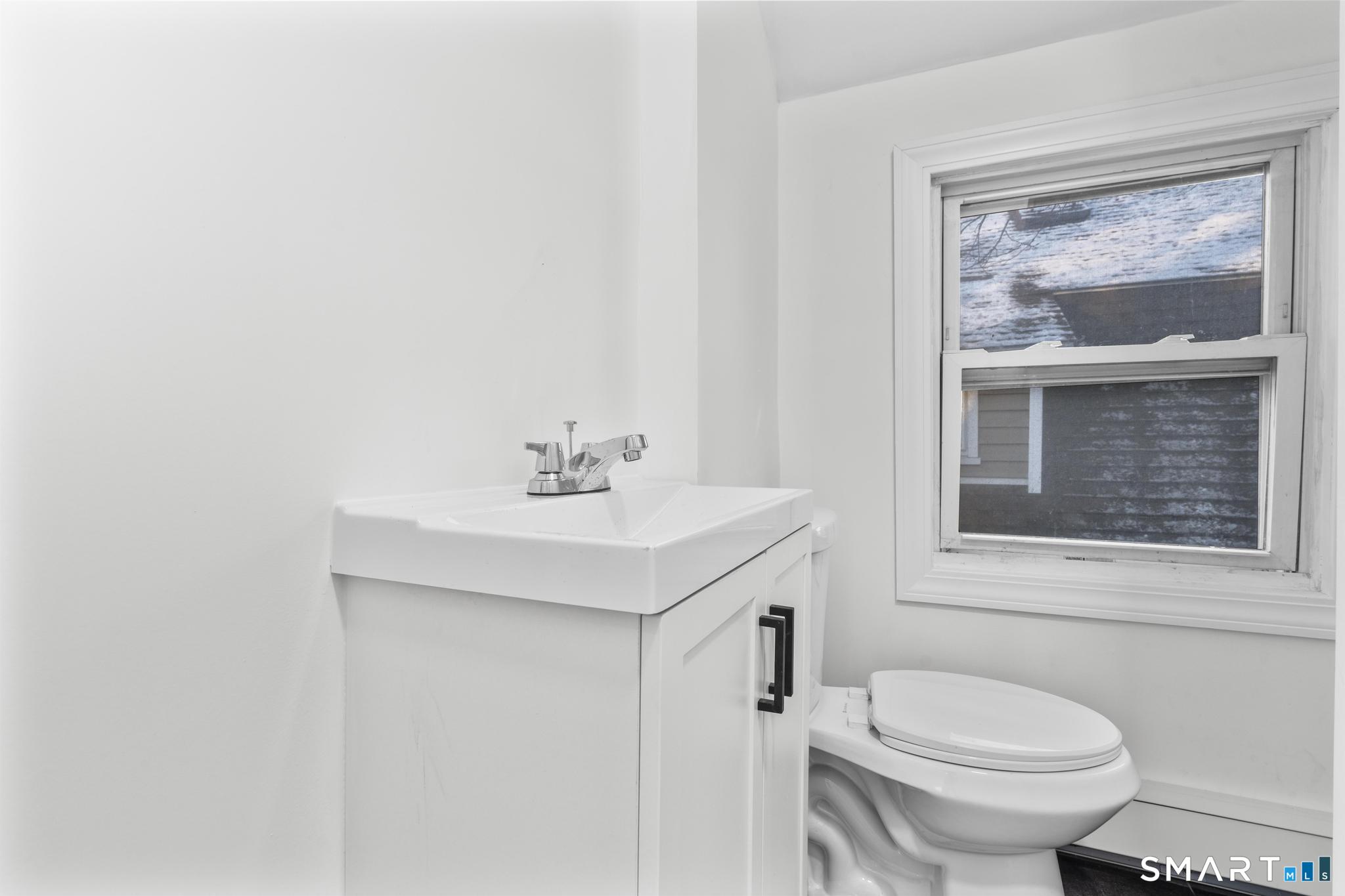141 Augur Street Hamden, CT 06517 - Photo 11 of 25 a bathroom with a sink mirror and toilet