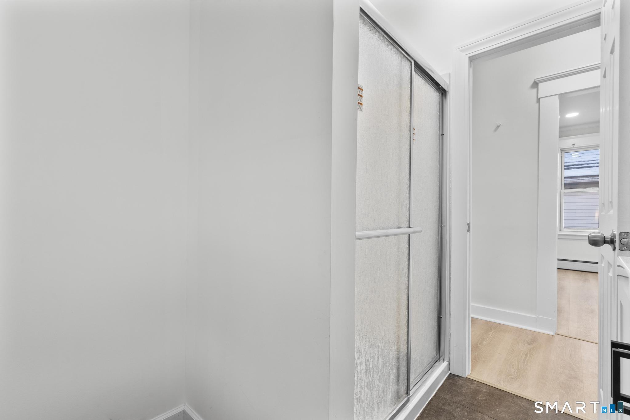 141 Augur Street Hamden, CT 06517 - Photo 12 of 25 a view of a hallway with a wooden cabinets