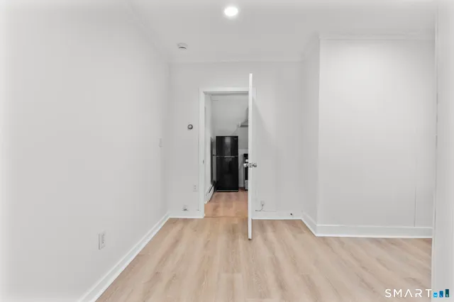 a view of a room with wooden floor and entrance