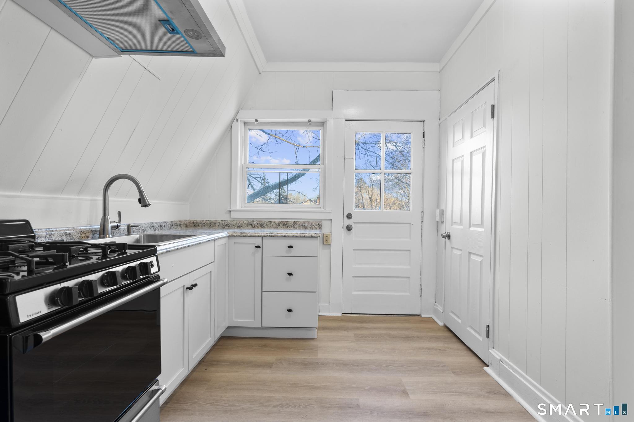 141 Augur Street Hamden, CT 06517 - Photo 18 of 25 a kitchen with granite countertop a stove and a sink