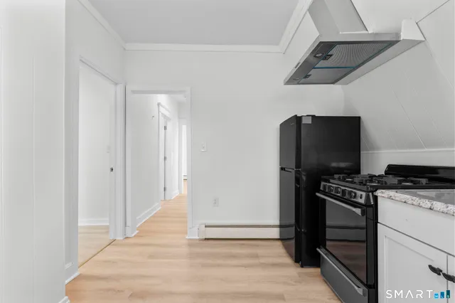a kitchen with a stove and a refrigerator