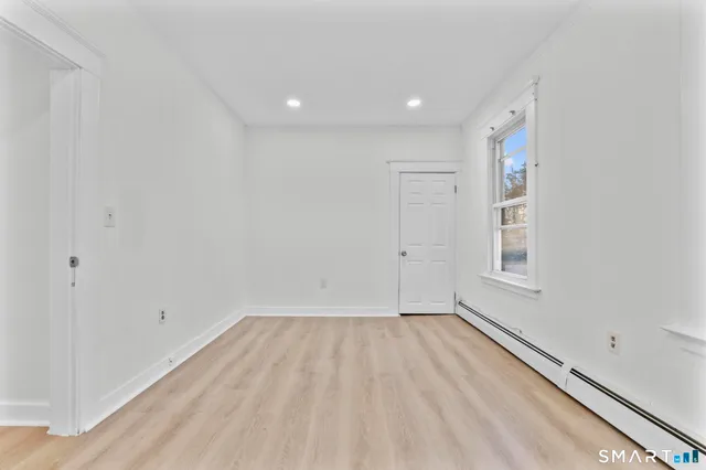 a view of room with window and hardwood floor