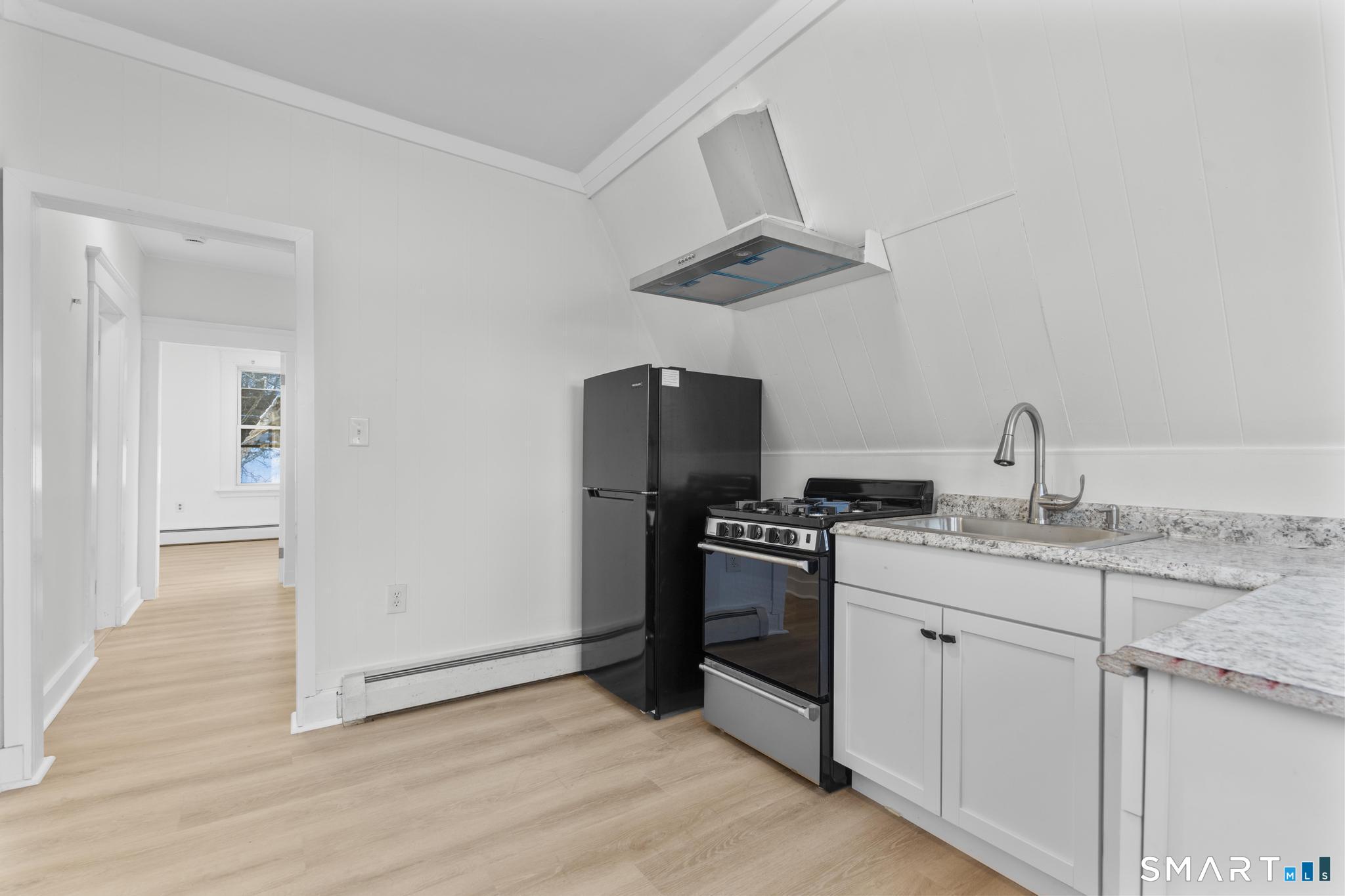 141 Augur Street Hamden, CT 06517 - Photo 23 of 25 a kitchen with stainless steel appliances granite countertop a sink a stove and a refrigerator