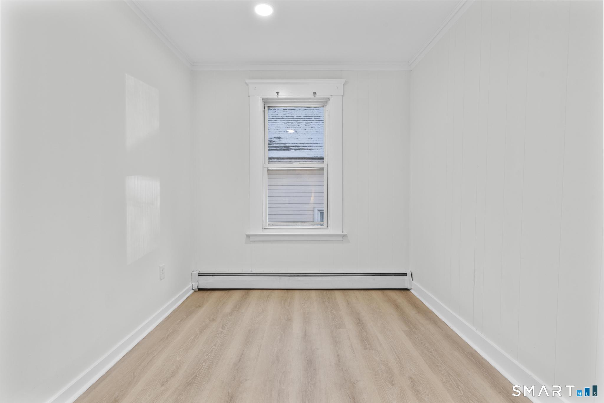 141 Augur Street Hamden, CT 06517 - Photo 7 of 25 a view of an empty room with wooden floor and a window