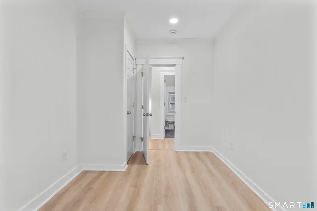 a view of a room with wooden floor