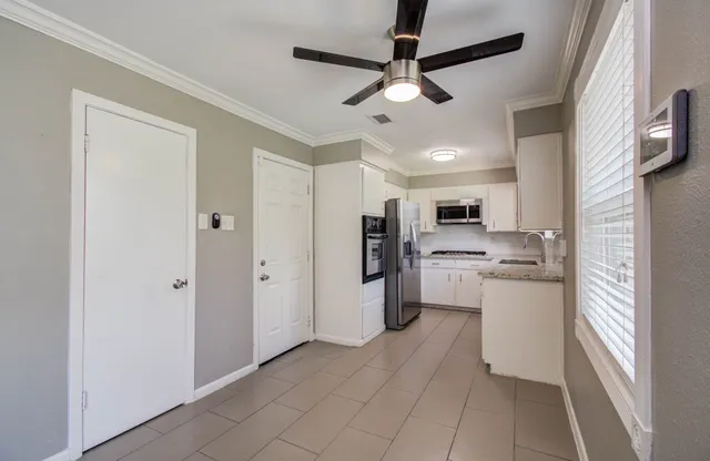 a kitchen with refrigerator cabinets and furniture