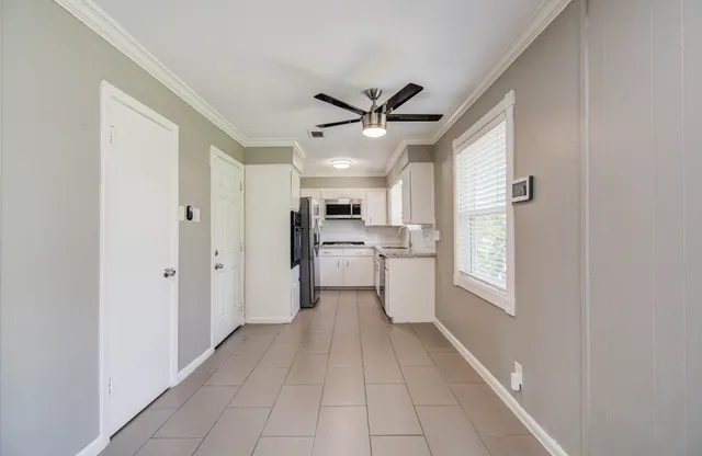 a view of a hallway with a kitchen
