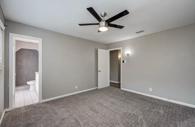 wooden floor in an empty room and a bathroom