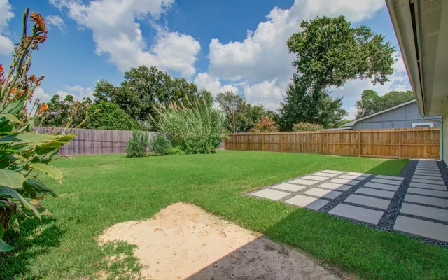 a view of yard with patio
