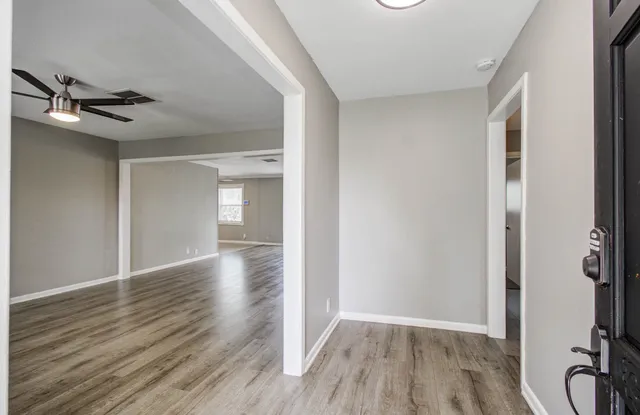 a view of hallway with wooden floor