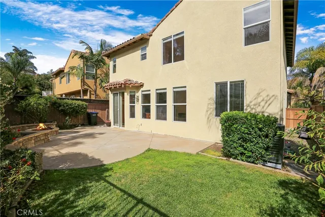 a view of a white house with a yard and plants