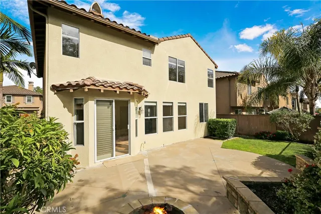a view of a white house with a yard and potted plants