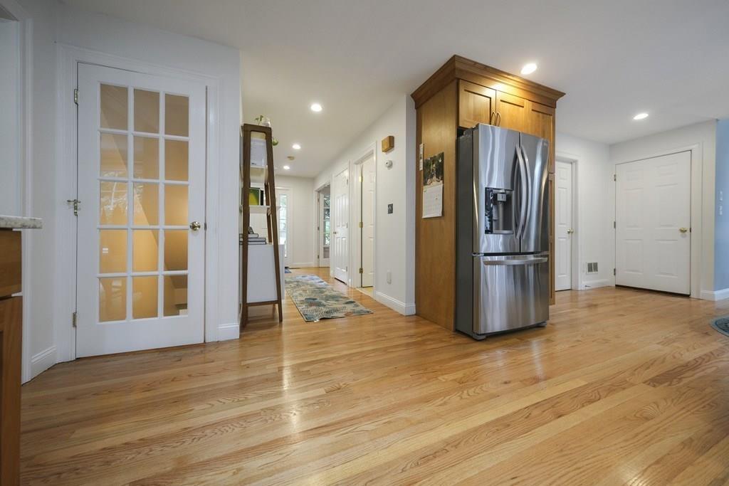 58 Williams Road Lexington, MA 02420 - Photo 11 of 33 a view of an empty room with wooden floor and a kitchen