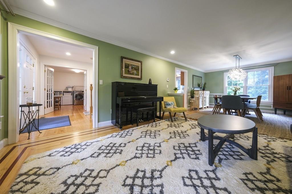 58 Williams Road Lexington, MA 02420 - Photo 4 of 33 a living room with furniture a flat screen tv and kitchen view