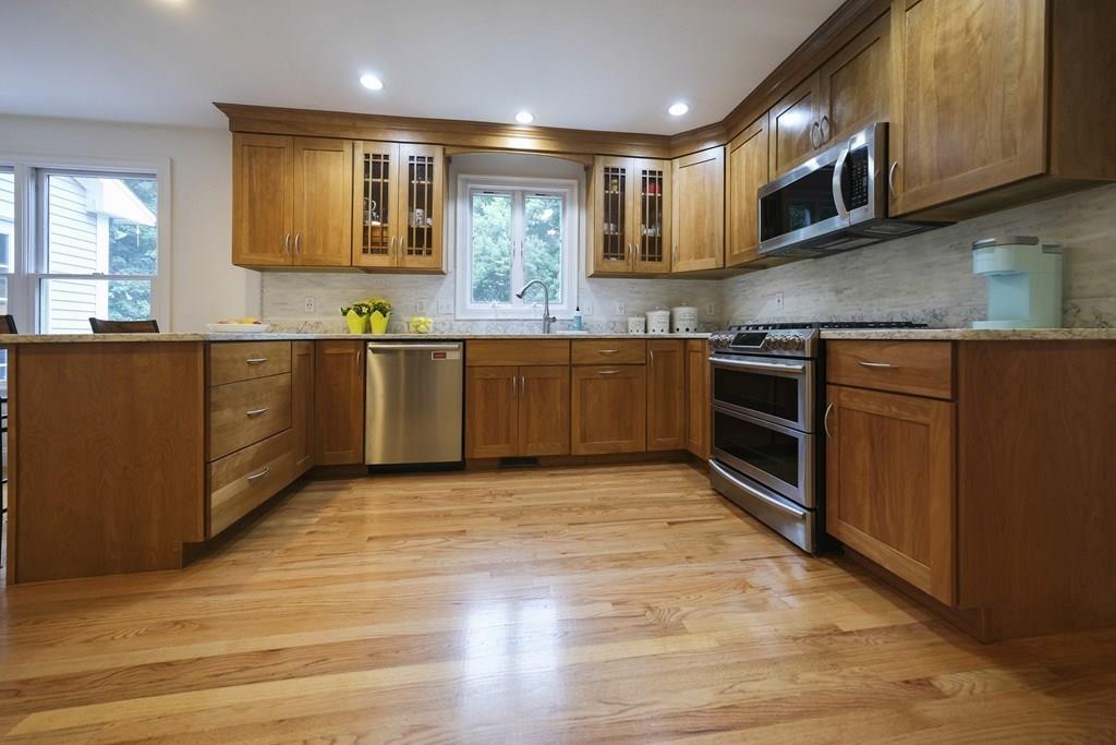 58 Williams Road Lexington, MA 02420 - Photo 8 of 33 a large kitchen with stainless steel appliances granite countertop a stove a sink and a microwave